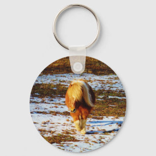 Brown and cream miniature horse in the snow. key ring