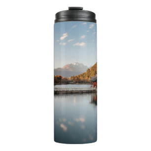 BROWN AND GREEN PAGODA ON BODY OF WATER NEAR MOUNT THERMAL TUMBLER