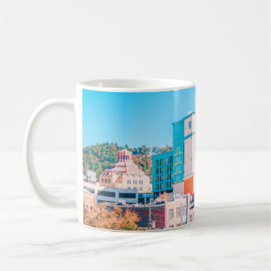 BROWN AND WHITE CONCRETE BUILDING UNDER BLUE SKY COFFEE MUG