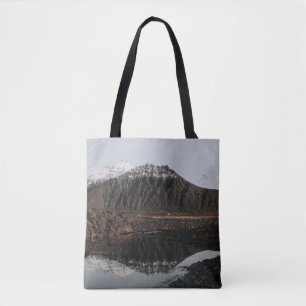 BROWN AND WHITE MOUNTAINS NEAR LAKE DURING DAYTIME TOTE BAG