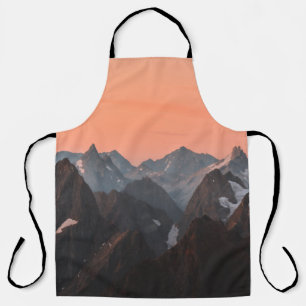 BROWN AND WHITE MOUNTAINS UNDER ORANGE SKY APRON