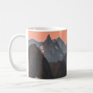 BROWN AND WHITE MOUNTAINS UNDER ORANGE SKY COFFEE MUG
