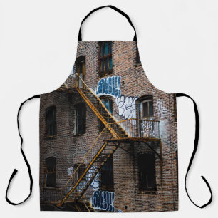 BROWN BRICK BUILDING WITH YELLOW METAL LADDER APRON