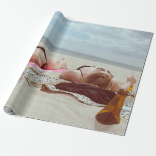 Brown glass bottle across two women wrapping paper