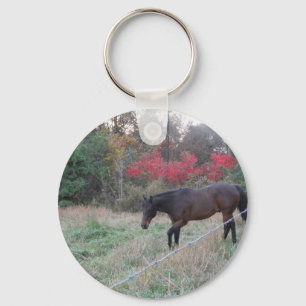 Brown horse in the red autumn trees key ring
