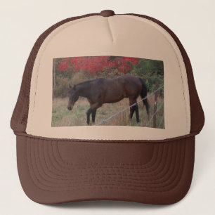 Brown horse in the red autumn trees trucker hat