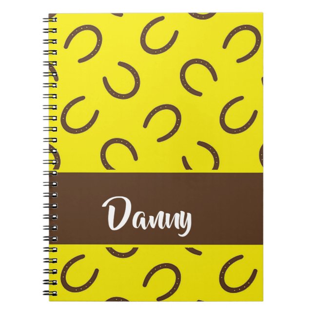 Brown horseshoes on yellow notebook (Front)