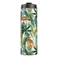 Brown leopard in tropical lush jungle leaves