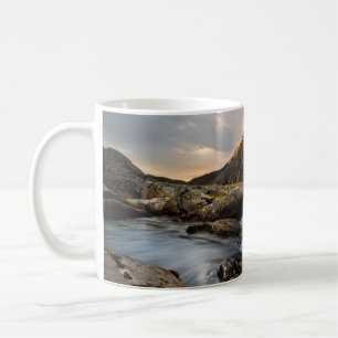 BROWN MOUNTAIN NEAR BODY OF WATER UNDER CLOUDY SKY COFFEE MUG