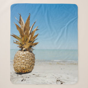 Brown pineapple fruit on seashore sherpa blanket