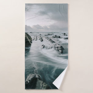 BROWN ROCK AND CLIFF SURROUNDED BODY OF WATER BATH TOWEL