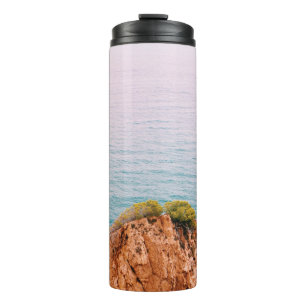 Brown rock mountain on body of water thermal tumbler