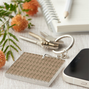 Brown rug featuring a detailed motif pattern with  key ring