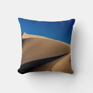 BROWN SAND UNDER BLUE SKY DURING DAYTIME CUSHION