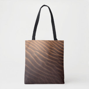 Brown sand with water in the morning tote bag