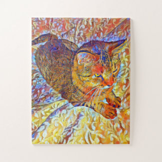 Brown tabby cat resting on a comfy bed jigsaw puzzle