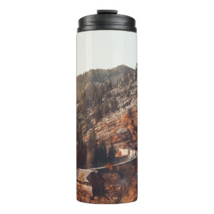 BROWN WOODEN BRIDGE ON BROWN ROCKY MOUNTAIN DURING THERMAL TUMBLER