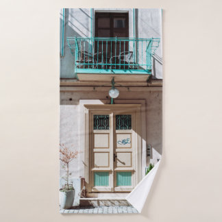 Brown wooden door on white concrete building bath towel