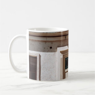 Brown wooden door on white concrete building coffee mug