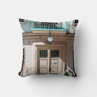 Brown wooden door on white concrete building cushion