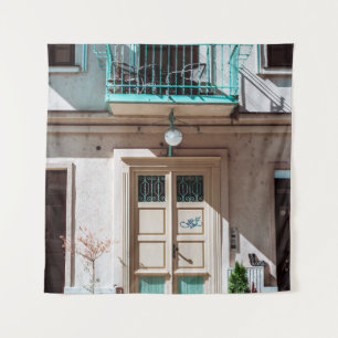 Brown wooden door on white concrete building tapestry