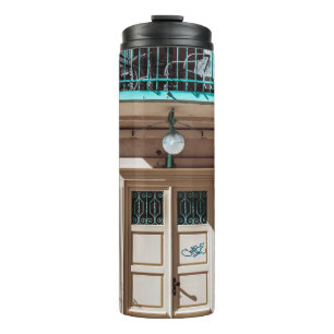 Brown wooden door on white concrete building thermal tumbler