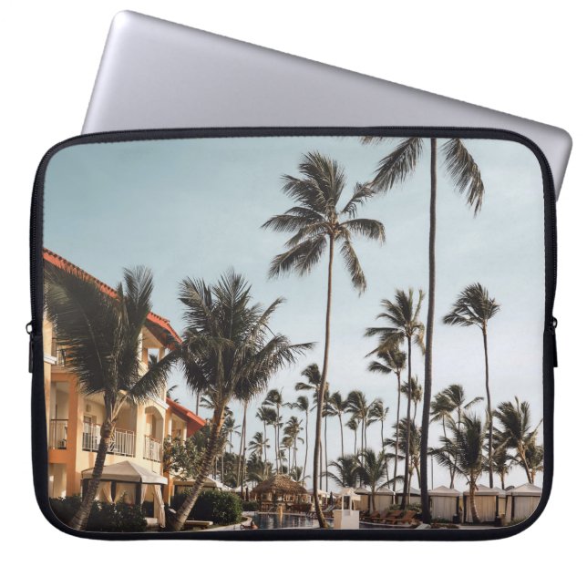 Brown wooden lounge chairs near pool surrounded by laptop sleeve (Front)