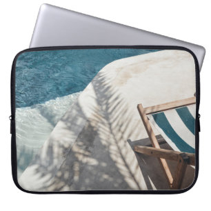 Brown wooden lounger near body of water laptop sleeve