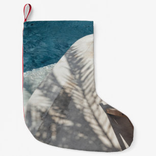 Brown wooden lounger near body of water small christmas stocking