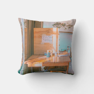 BROWN WOODEN TABLE WITH WHITE PRINTER PAPER CUSHION