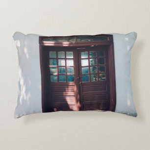 BROWN WOODEN WINDOW ON BLUE CONCRETE WALL DECORATIVE CUSHION