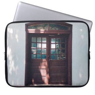 BROWN WOODEN WINDOW ON BLUE CONCRETE WALL LAPTOP SLEEVE