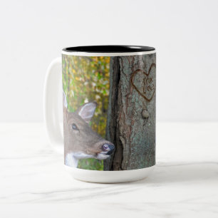 buck and doe with heart on tree Two-Tone coffee mug