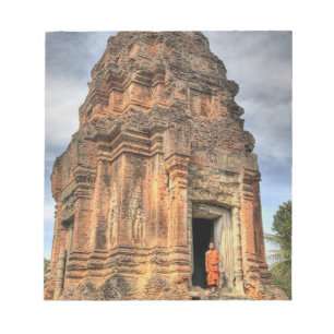 Buddhist monk standing in doorway of temple notepad