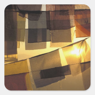 Buddhist prayer flags in the sunset, square sticker