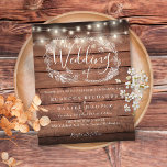 Budget Rustic Wood String Light Wedding Invitation<br><div class="desc">Featuring pretty string lights and a hand-drawn floral garland,  this elegant budget rustic wood wedding invitation can be personalised with your information in chic lettering on a wood panels background. Designed by Thisisnotme©</div>