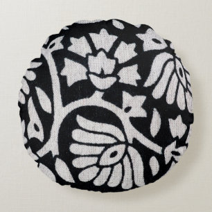 Bunches of plants and flowers abstract on a black round cushion