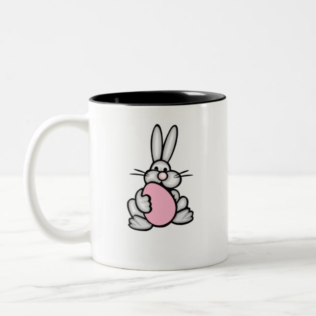 Bunny holding a Light Pink Egg Two-Tone Coffee Mug (Left)