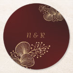 Burgundy & Gilded Floral Elegant Wedding Round Paper Coaster<br><div class="desc">Protect your surfaces with style using these luxurious wedding coasters. Featuring a deep burgundy gradient background,  delicate gold botanical line art,  and a customizable monogram,  they are the perfect functional accent for cocktail hours,  receptions,  or engagement parties.</div>