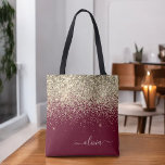 Burgundy Gold Glitter Girly Monogram Glam Tote Bag<br><div class="desc">Gold and Burgundy Faux Sparkle and Glitter Elegant Monogram Book Bag. This Book Bag can be customised to include your initial and first name and given as a gift for Christmas,  Sweet 16 Birthday,  Bridal Shower or a Wedding.</div>