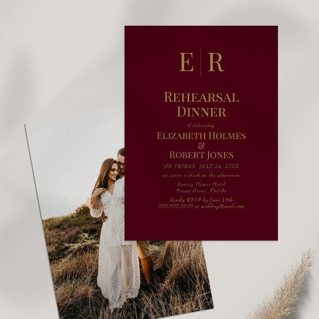 Burgundy Gold Monogram Rehearsal Dinner Invitation (Burgundy Monogram Custom Photo Rehearsal Dinner Invitation on white table with dry wildflower.)