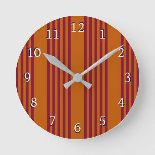 Burgundy red and burnt orange five stripe pattern. round clock
