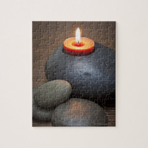 Burning candle flame with rocks in tranquil jigsaw puzzle