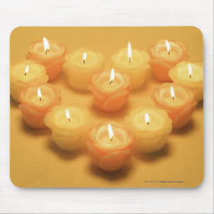 Burning candles arranged in a heart shape mouse pad