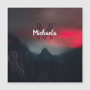 Burning clouds, fog and mountains monogram in sky