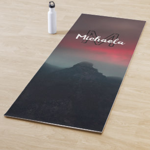 Burning clouds, fog and mountains monogram in sky yoga mat