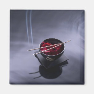 Burning incense on top of bowl of petals magnet