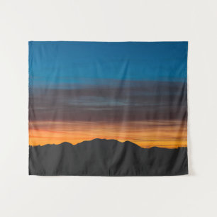 Burning sunset above landscape silhouette tapestry