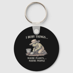 Bury things maybe plants maybe people frog key ring