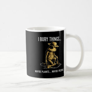 Bury things maybe plants maybe people funny frog coffee mug